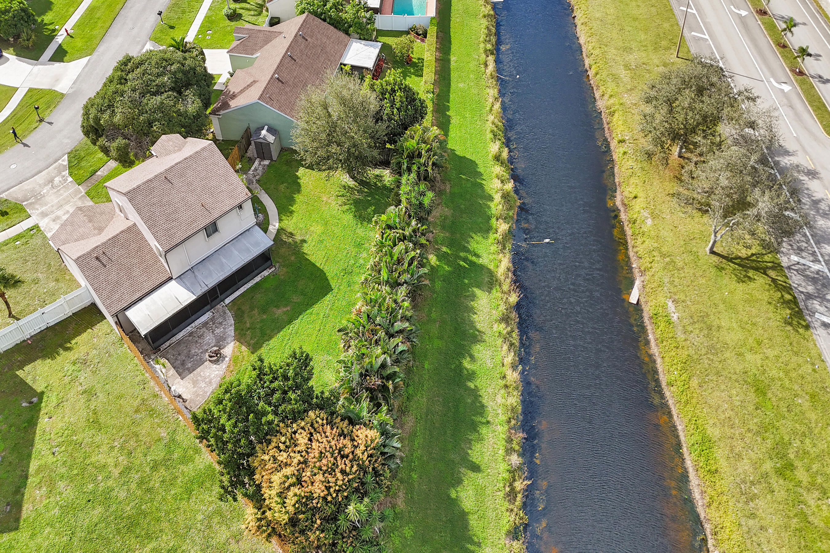 9855 Robins Nest Road Boca Raton, FL 33496 - Photo 76 of 84 an aerial view of a house with swimming pool and garden