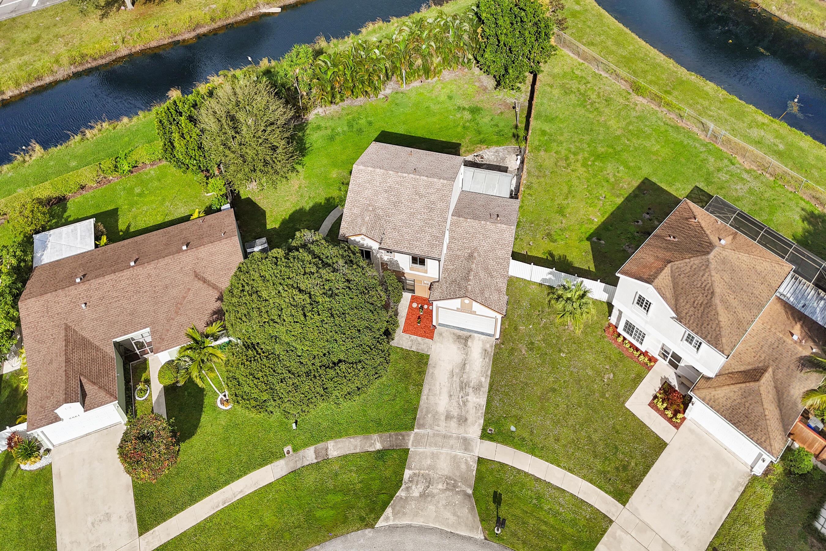 9855 Robins Nest Road Boca Raton, FL 33496 - Photo 78 of 84 an aerial view of a house with a garden and swimming pool