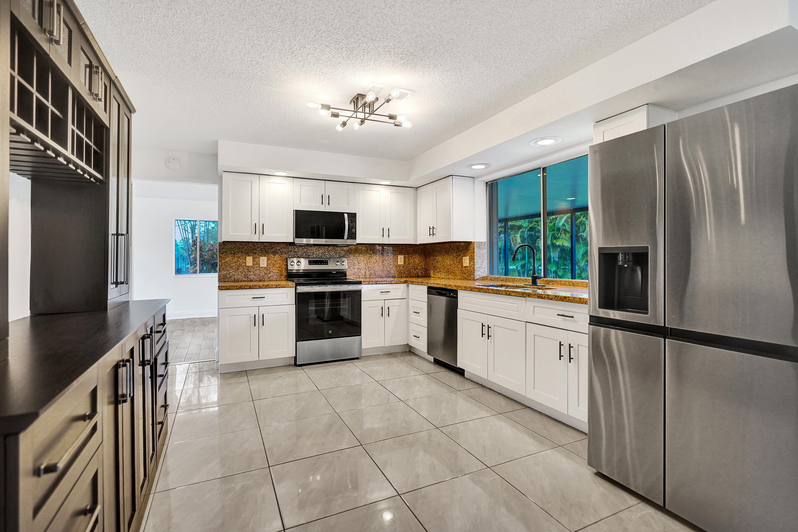 9855 Robins Nest Road Boca Raton, FL 33496 - Photo 8 of 84 a kitchen with stainless steel appliances granite countertop a refrigerator sink and cabinets