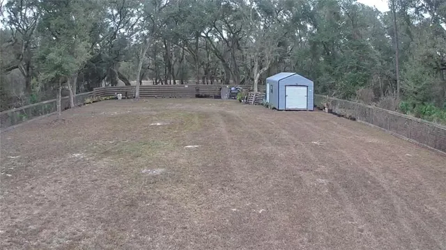 a backyard of a house with table and chairs
