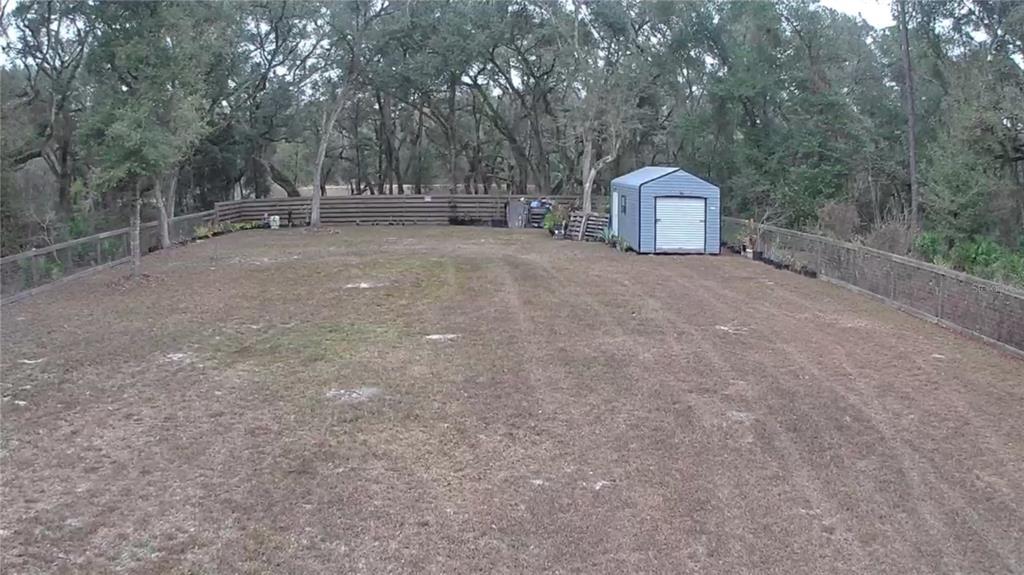 33469 August Avenue Webster, FL 33597 - Photo 3 of 5 a backyard of a house with table and chairs