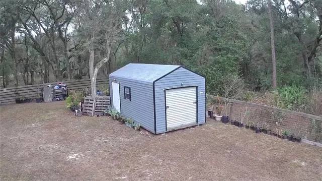 a view of a barn in the middle of a yard