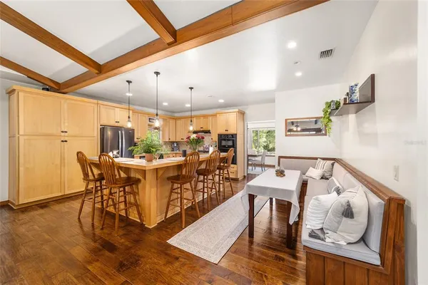 a view of a dining room with furniture window and wooden floor