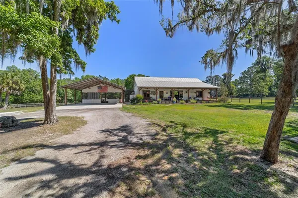 a view of a house with swimming pool and porch with furniture