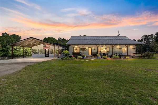 a view of a house with backyard porch and sitting area