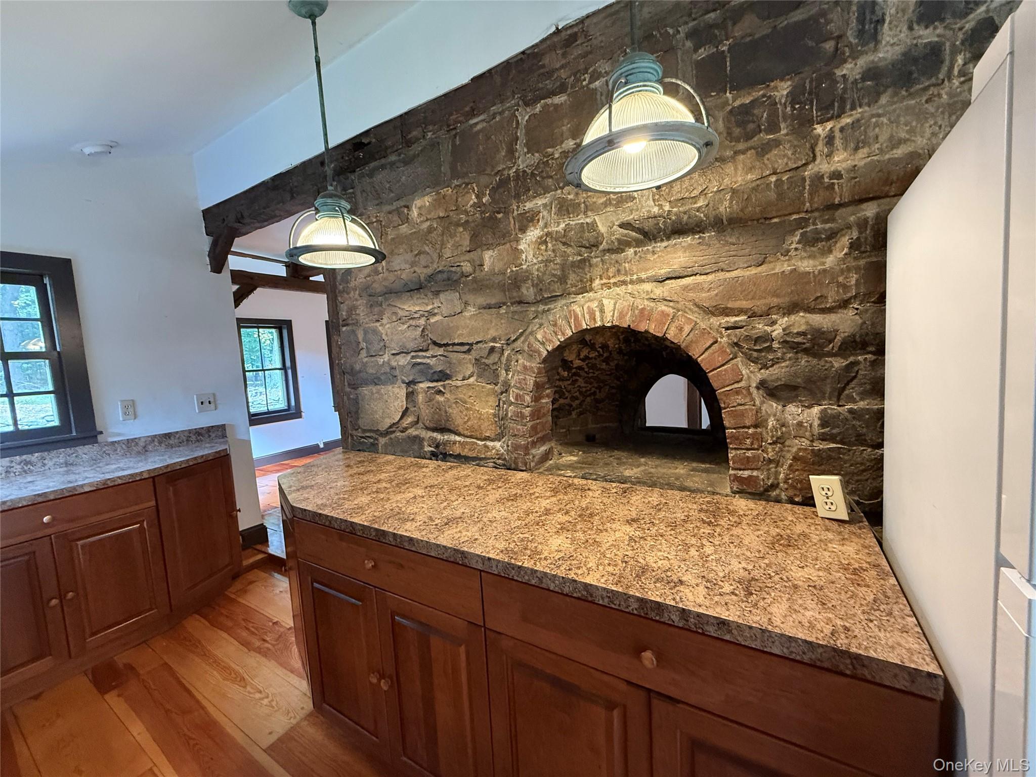 241 White Bridge Road Middletown, NY 10940 - Photo 18 of 29 Kitchen featuring light wood-type flooring, decorative light fixtures, and brown cabinetry