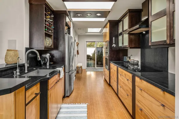 a large kitchen with lots of counter space and stainless steel appliances