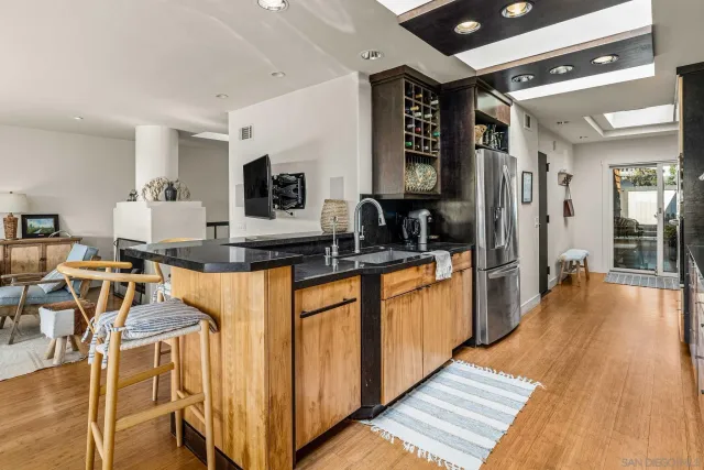 a kitchen with stainless steel appliances a stove a sink and a refrigerator
