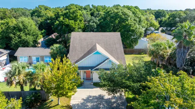 an aerial view of house with yard and outdoor seating