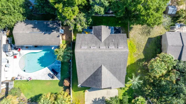 an aerial view of a house with a yard and garden