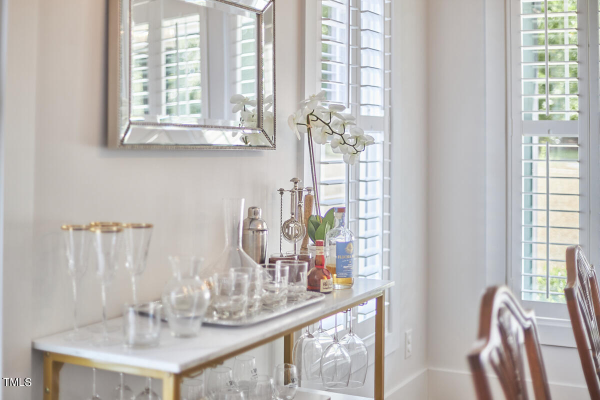 1019 Glascock Street Raleigh, NC 27610 - Photo 11 of 45 a dining room with furniture a chandelier and wooden floor