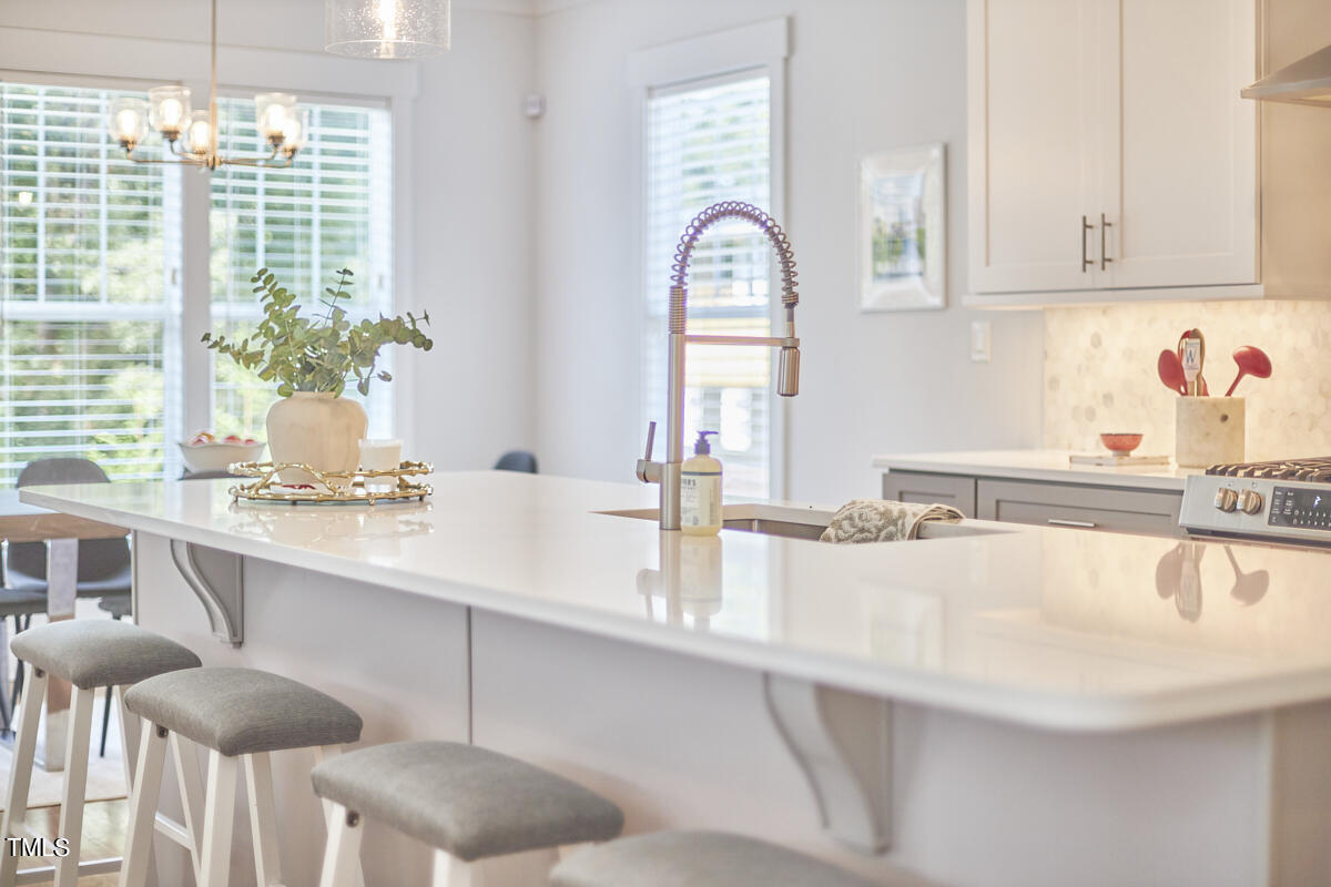 1019 Glascock Street Raleigh, NC 27610 - Photo 20 of 45 a kitchen with a sink cabinets and window