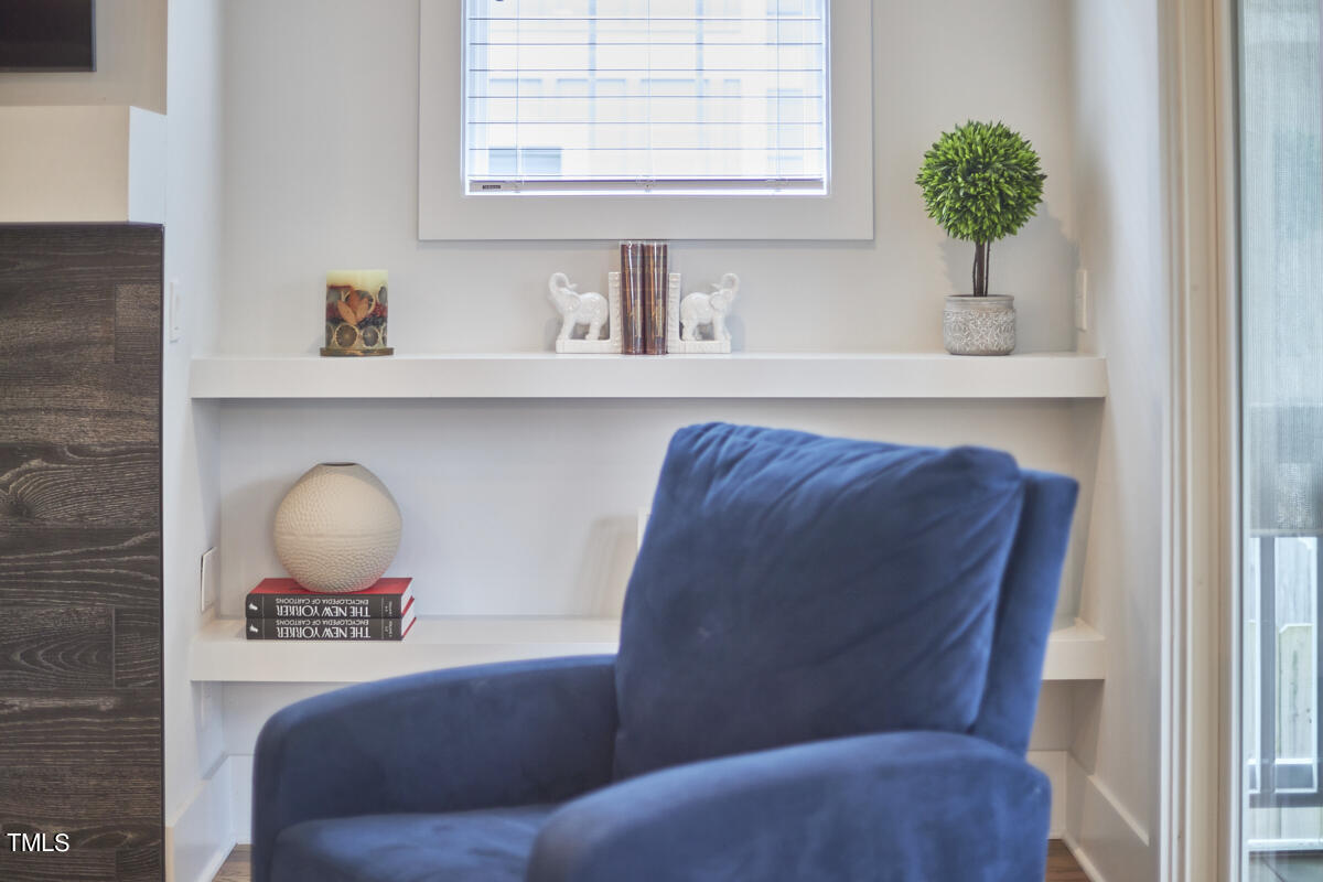 1019 Glascock Street Raleigh, NC 27610 - Photo 25 of 45 a living room with a couch and a potted plant