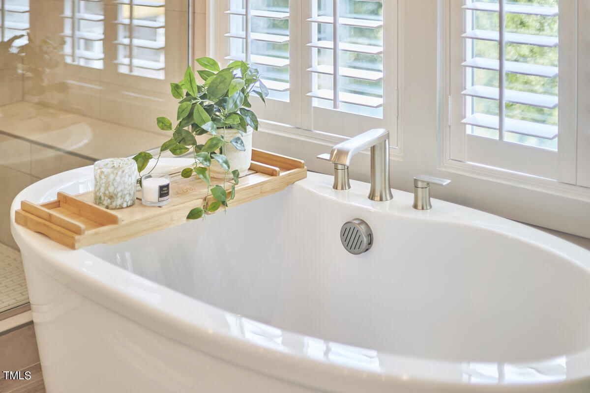 1019 Glascock Street Raleigh, NC 27610 - Photo 34 of 45 a bathroom with a granite countertop sink a large mirror and a shower