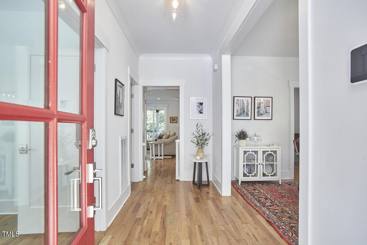 1019 Glascock Street Raleigh, NC 27610 - Photo 4 of 45 a view of a hallway with wooden floor and dining room