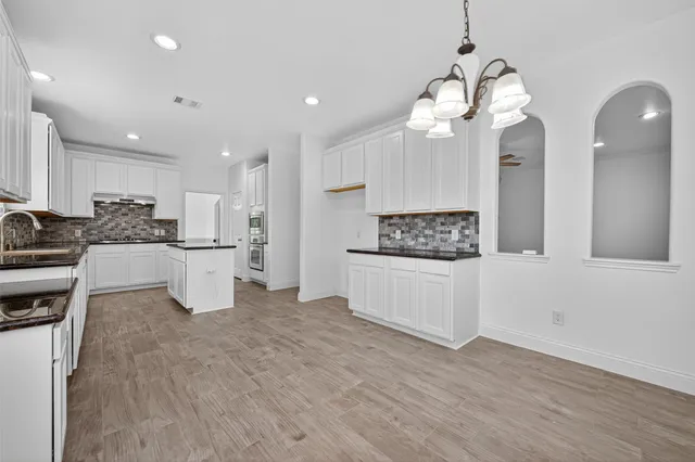a view of kitchen with sink microwave and refrigerator