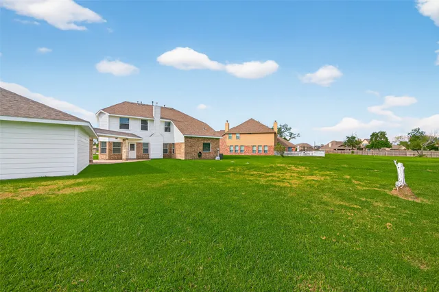 a view of a house with a backyard and a garden