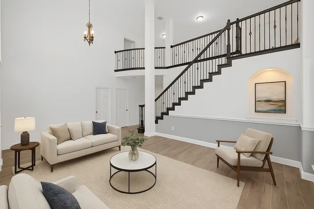 a living room with furniture and a dining table