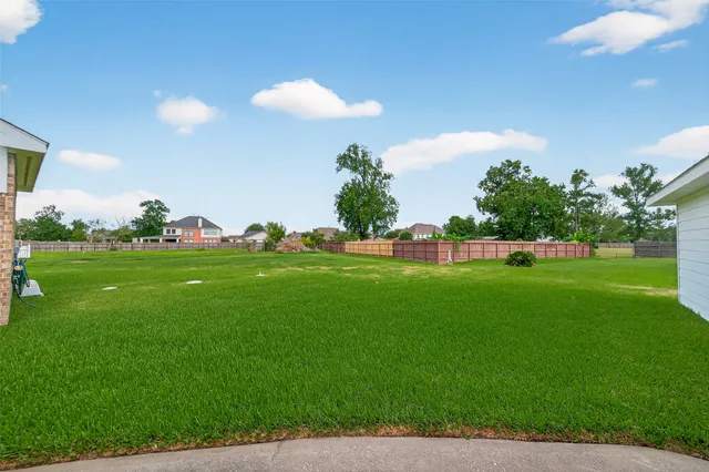 an aerial view of a house with a garden and houses