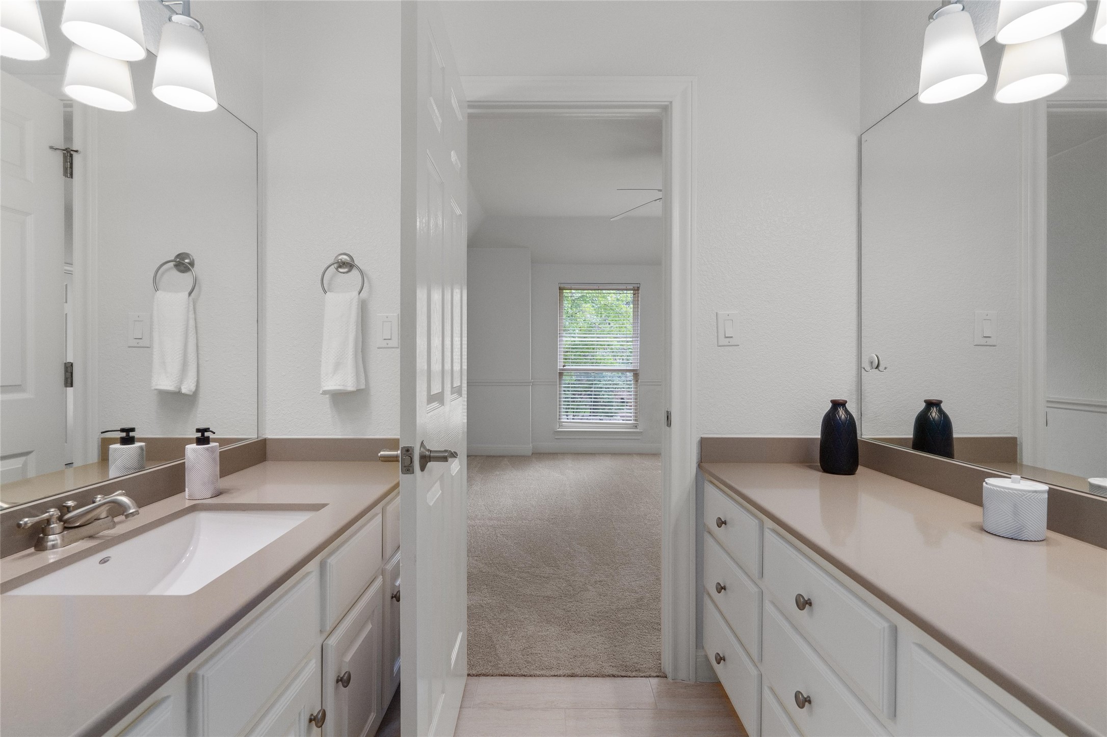 4313 Rio Robles Drive Austin, TX 78746 - Photo 31 of 40 Double vanities provide ample counter space and storage in this functional bathroom.