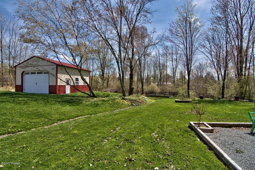 1058 Rosengrant Road Lake Ariel, PA 18436 - Photo 32 of 47 a front view of house with yard and trees