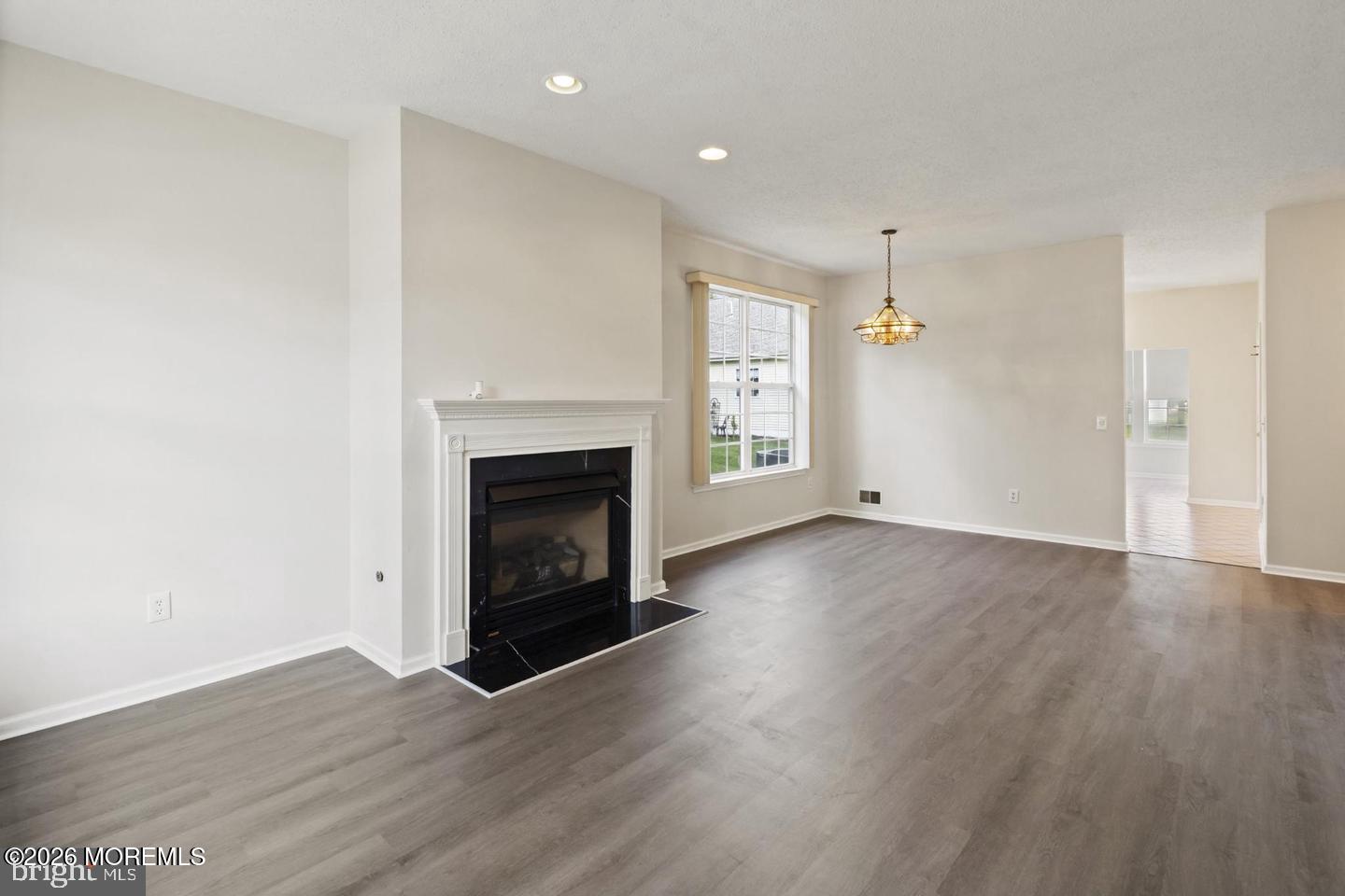 43 Osprey Place Barnegat, NJ 08005 - Photo 12 of 34 an empty room with wooden floor and fireplace