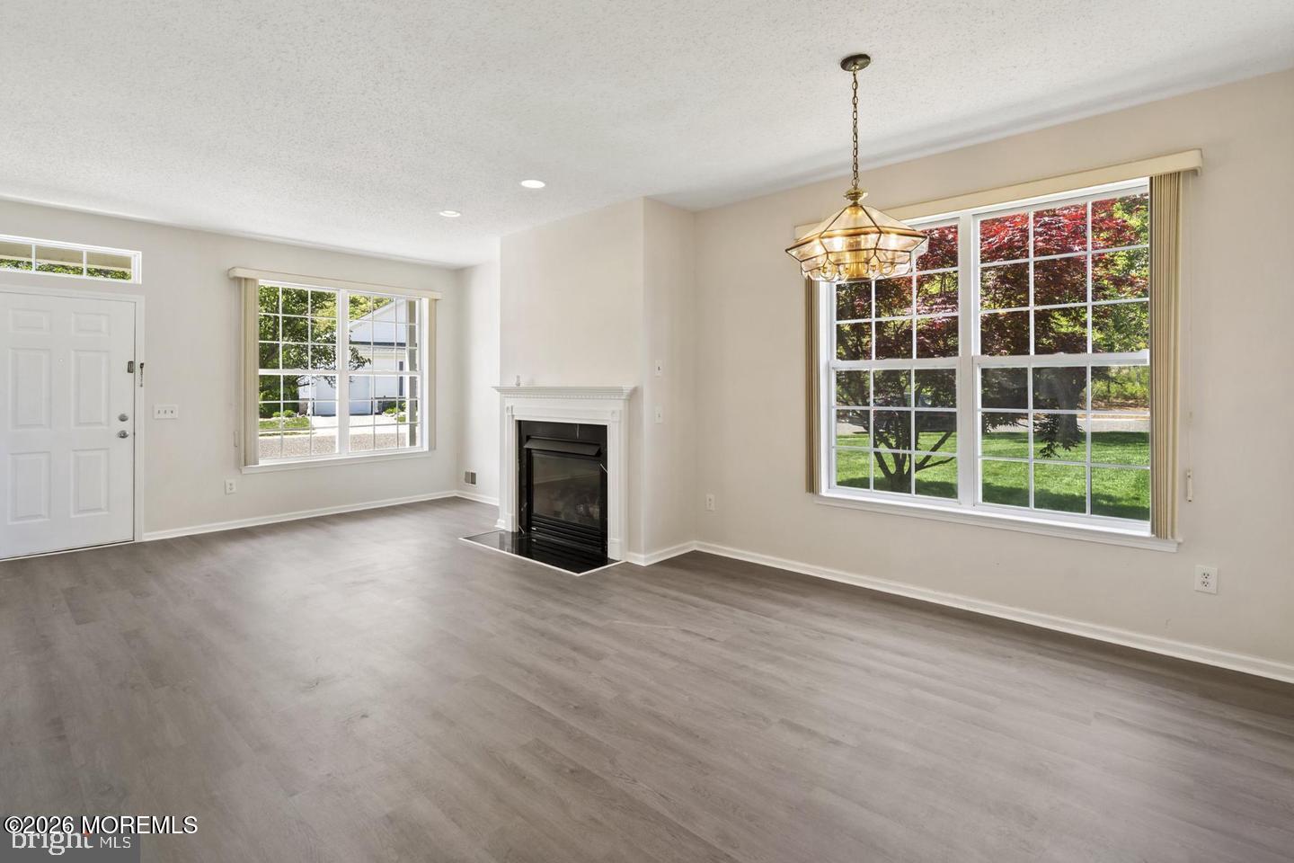 43 Osprey Place Barnegat, NJ 08005 - Photo 13 of 34 a view of empty room with wooden floor and fireplace