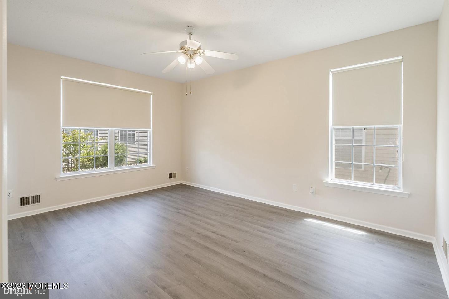 43 Osprey Place Barnegat, NJ 08005 - Photo 14 of 34 an empty room with wooden floor and windows