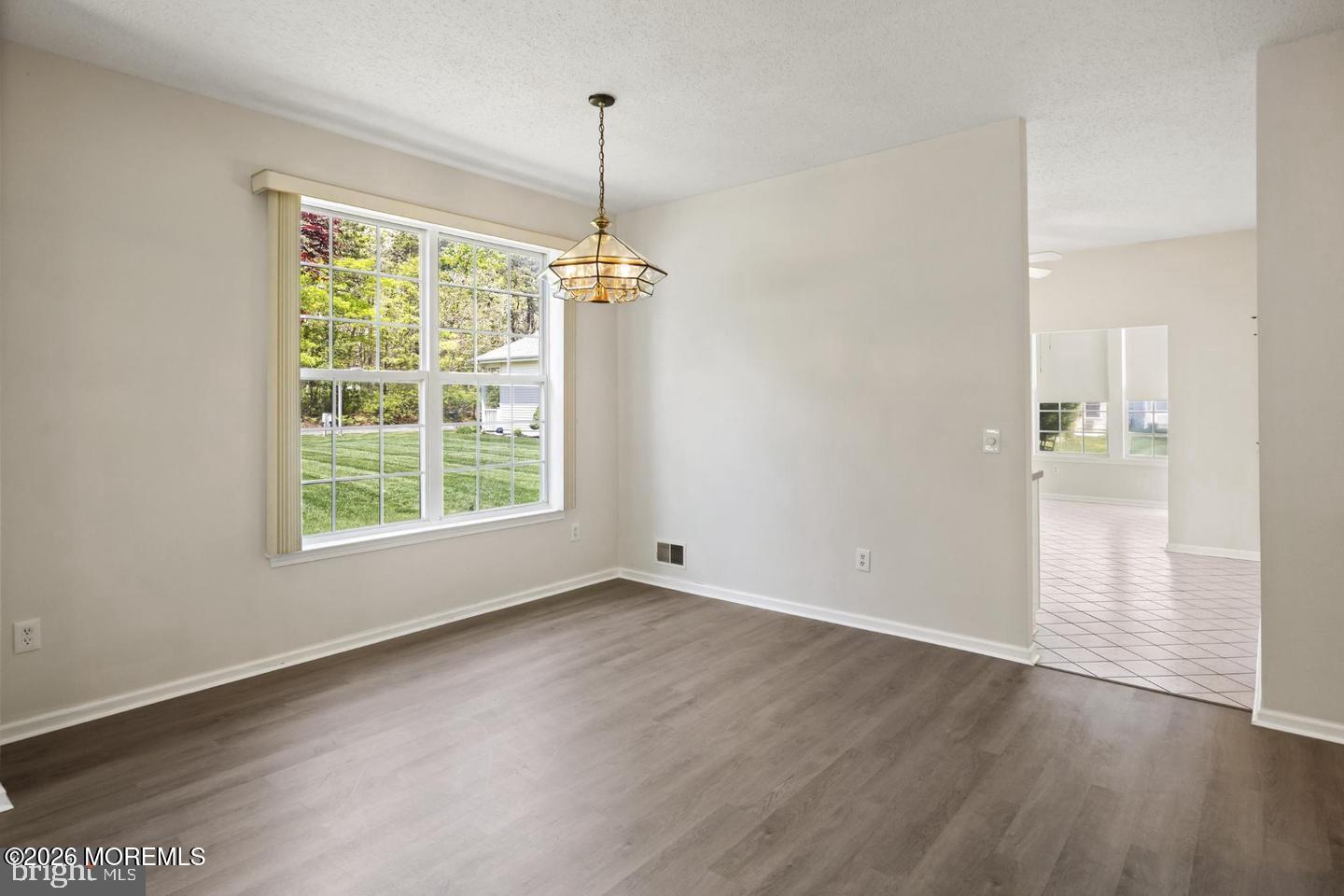 43 Osprey Place Barnegat, NJ 08005 - Photo 15 of 34 a view of an empty room with wooden floor kitchen view and a window