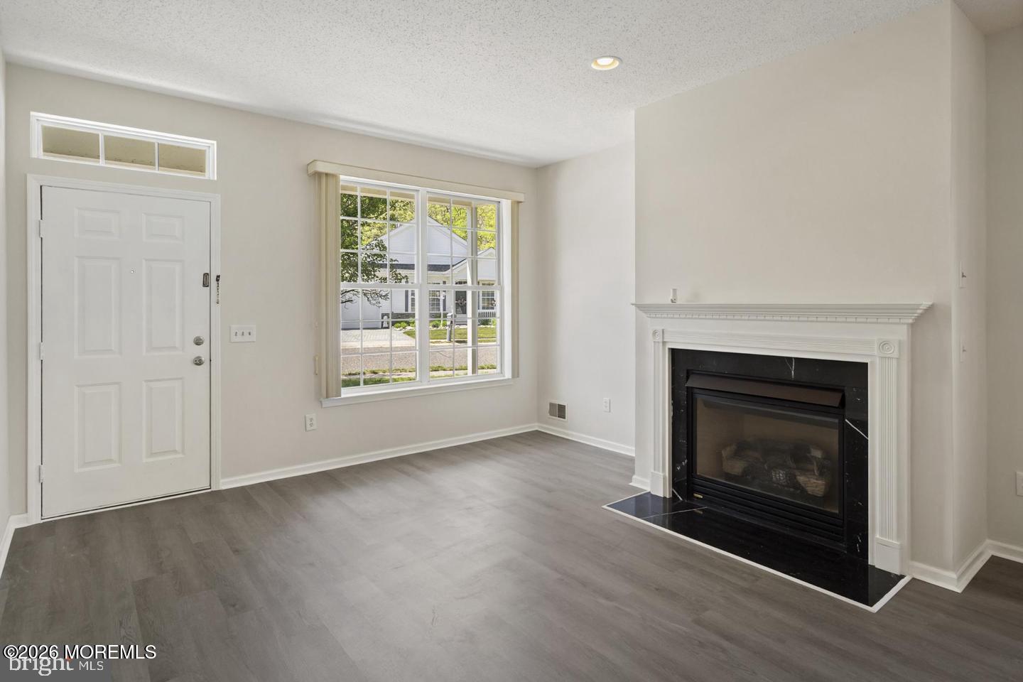 43 Osprey Place Barnegat, NJ 08005 - Photo 16 of 34 a view of an empty room with wooden floor fireplace and a window