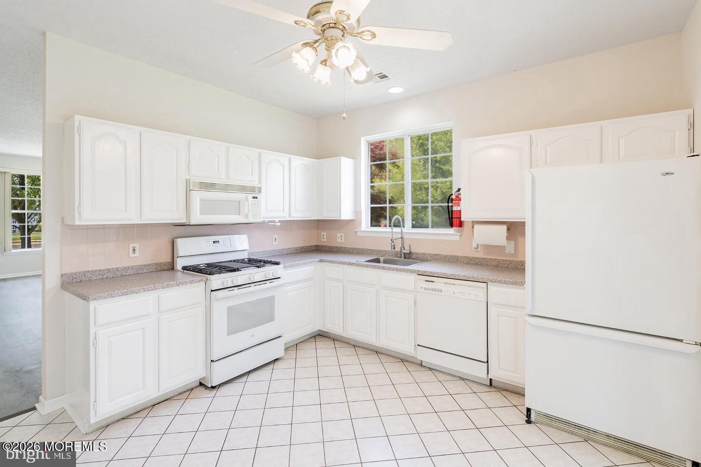 43 Osprey Place Barnegat, NJ 08005 - Photo 19 of 34 a kitchen with white cabinets and white appliances