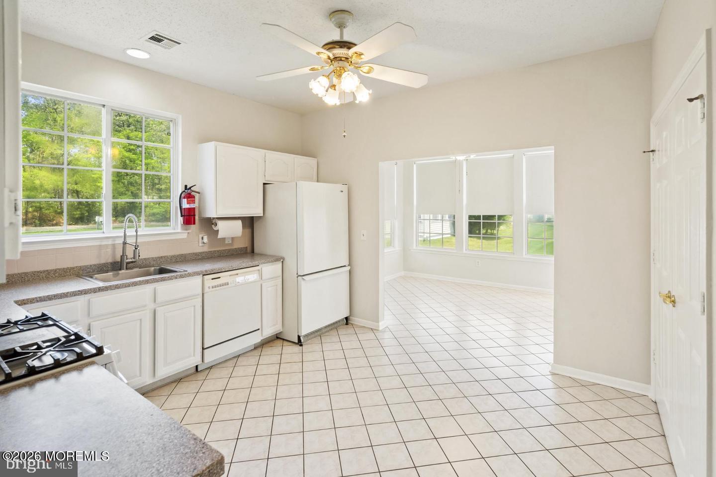 43 Osprey Place Barnegat, NJ 08005 - Photo 20 of 34 a kitchen with a white cabinets appliances and a window