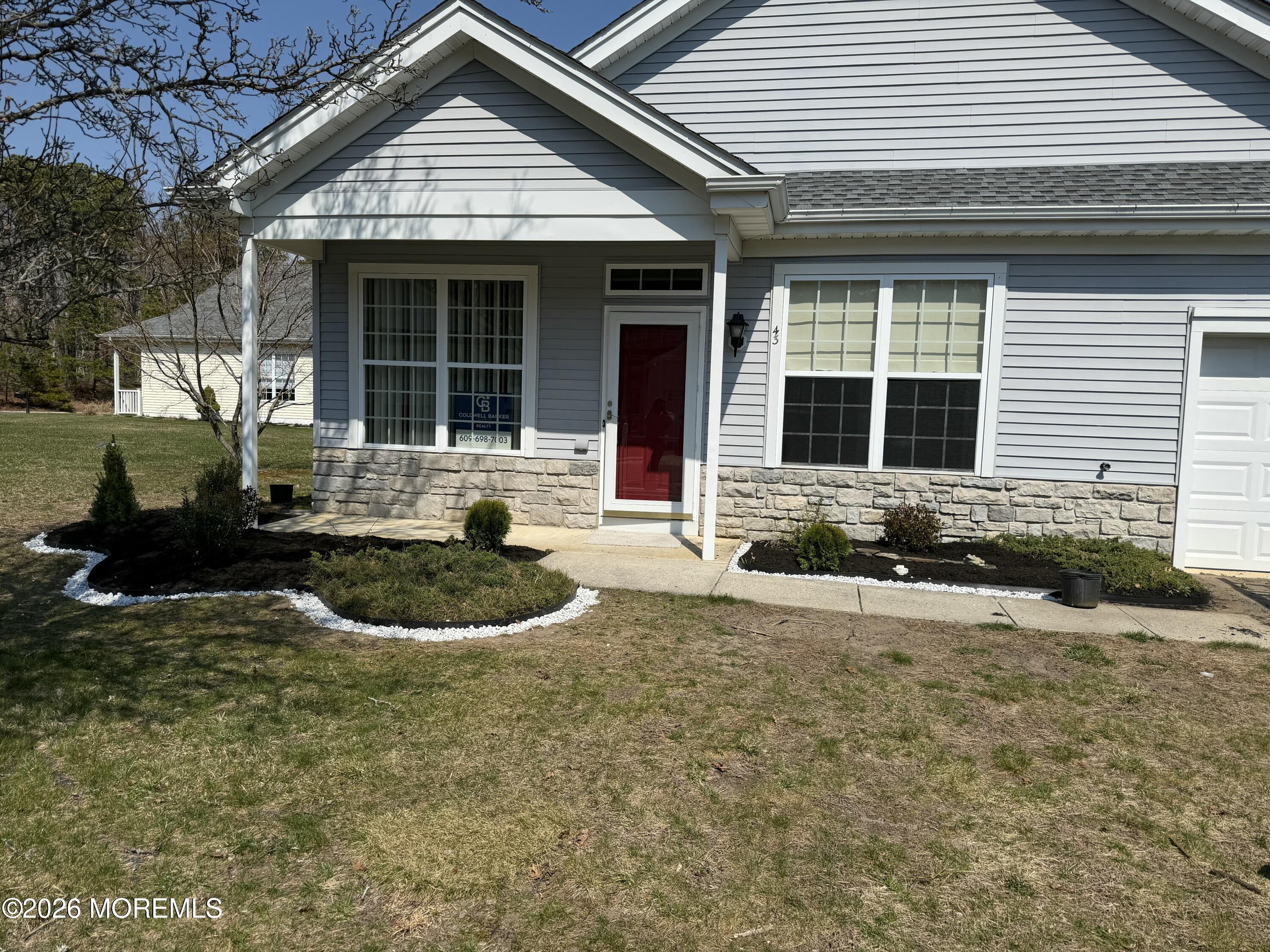 43 Osprey Place Barnegat, NJ 08005 - Photo 2 of 34 a front view of a house with garden and porch