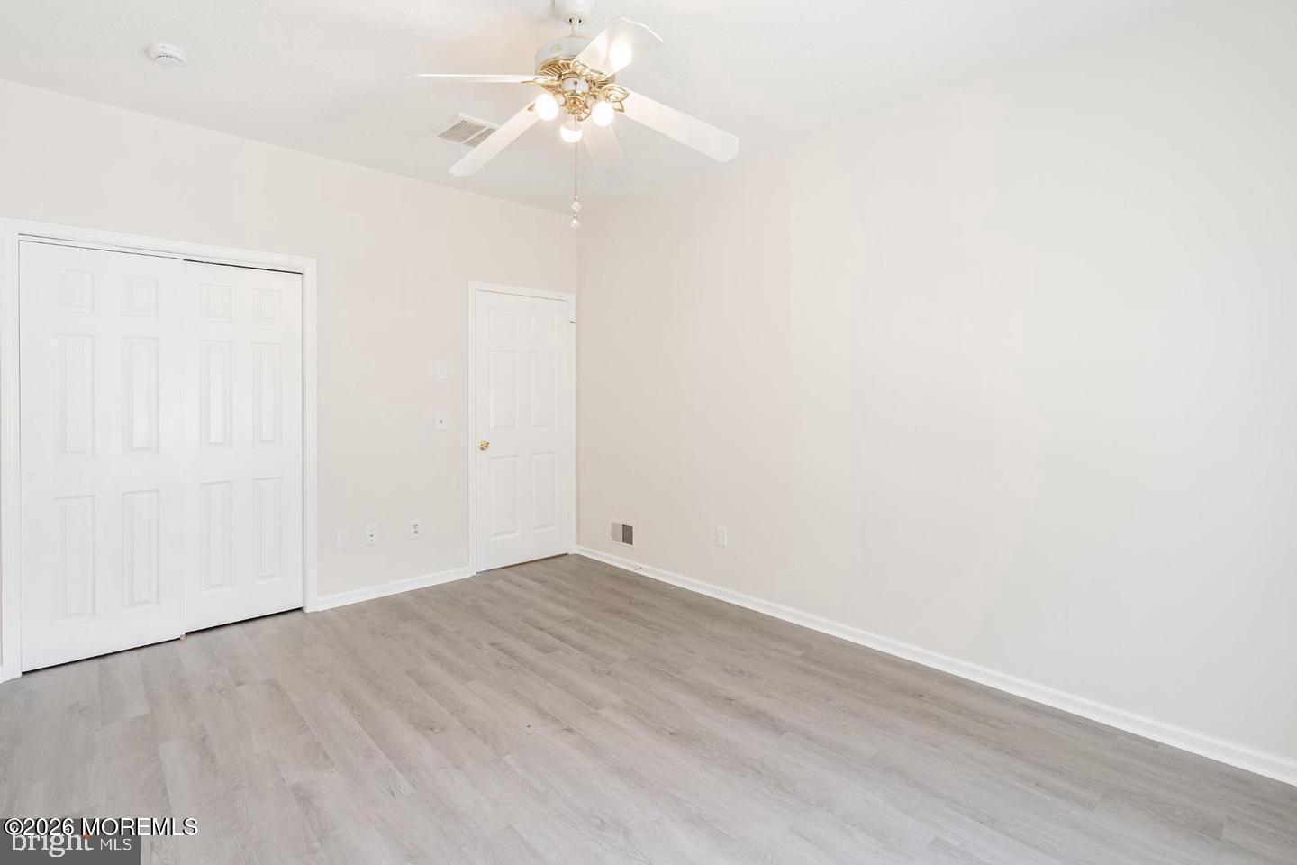 43 Osprey Place Barnegat, NJ 08005 - Photo 22 of 34 an empty room with a window and a ceiling fan
