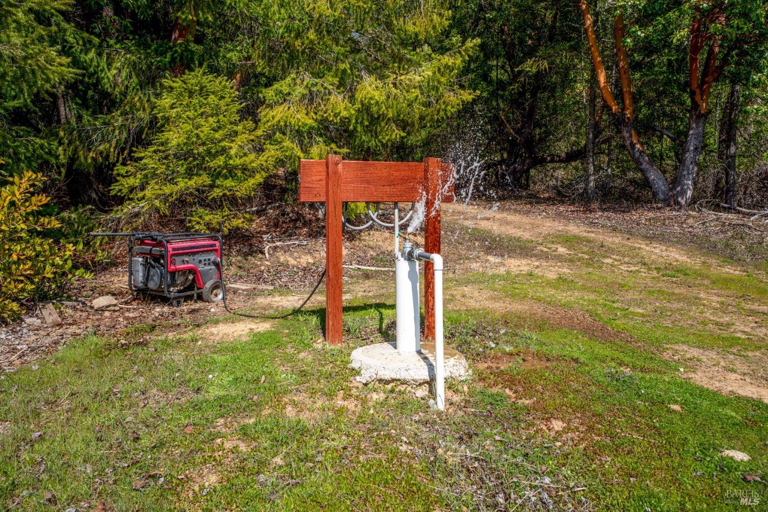 20401 Tomki Road Redwood Valley, CA 95470 - Photo 13 of 35 a backyard of a house with table and chairs
