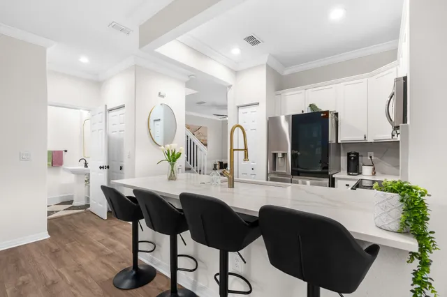 a kitchen with granite countertop a sink stainless steel appliances and cabinets