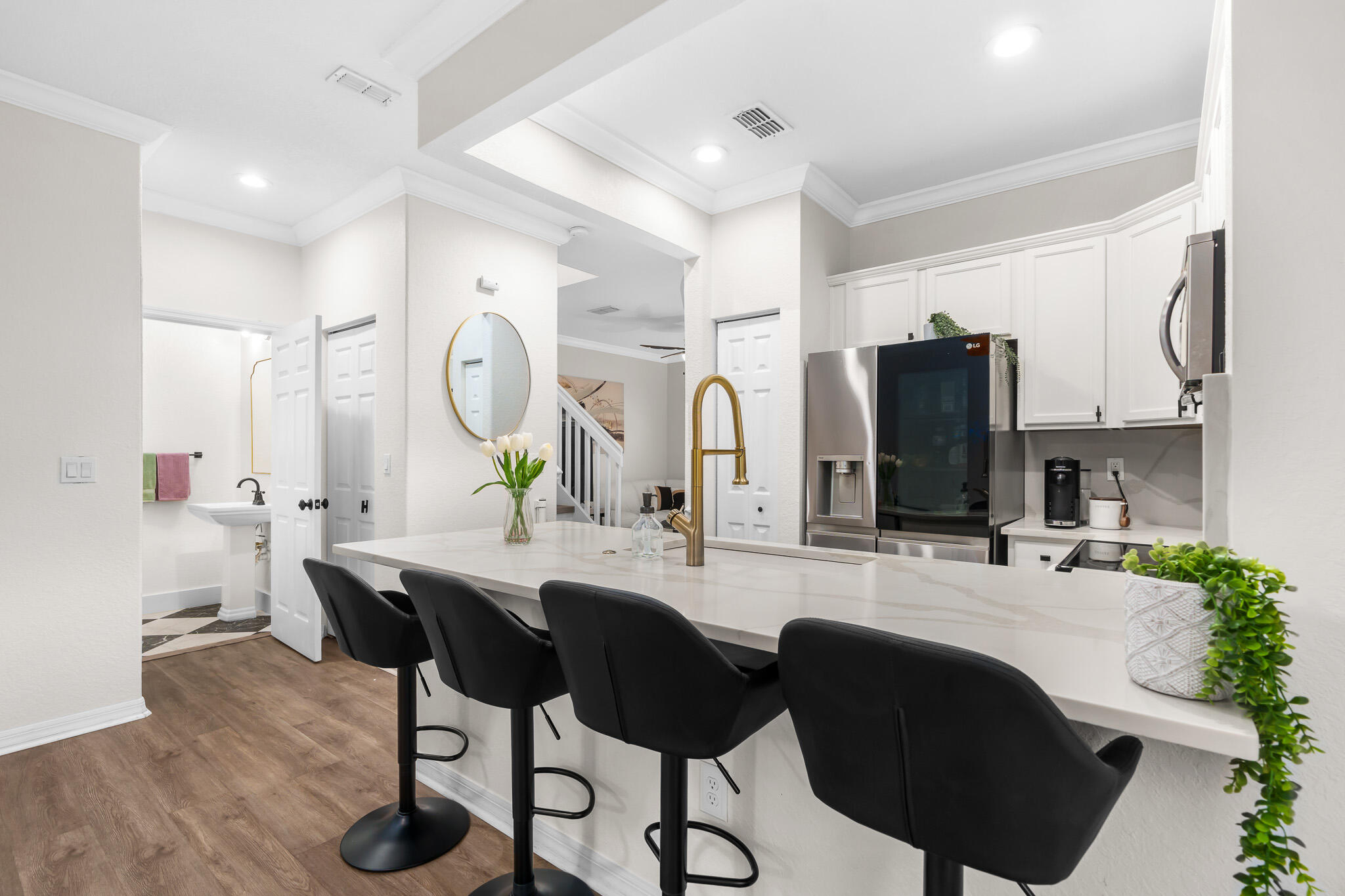 a kitchen with granite countertop a sink stainless steel appliances and cabinets