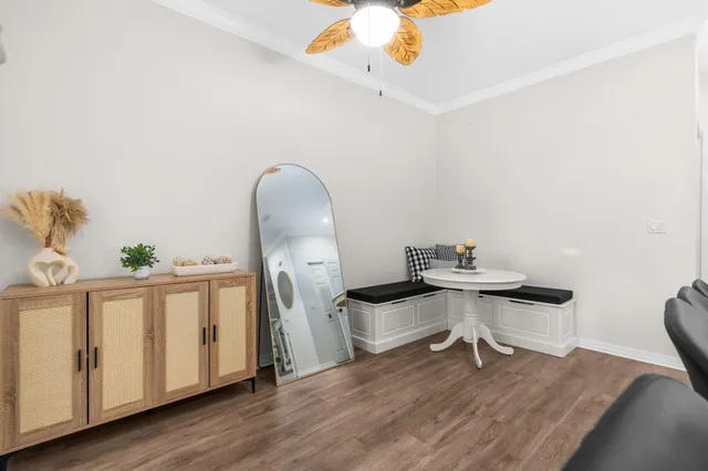 a view of a workspace with furniture and wooden floor