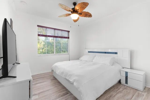 a bedroom with a bed and a window