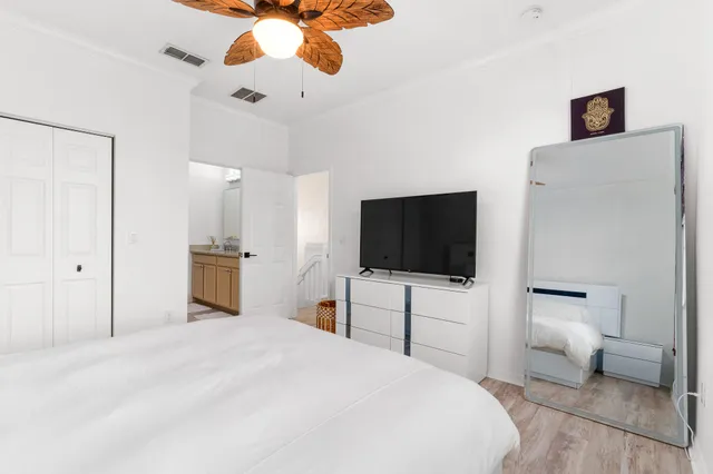 a bedroom with a bed and a flat screen tv