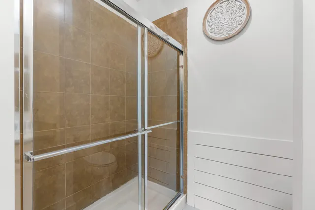 a bathroom with a large mirror and a shower