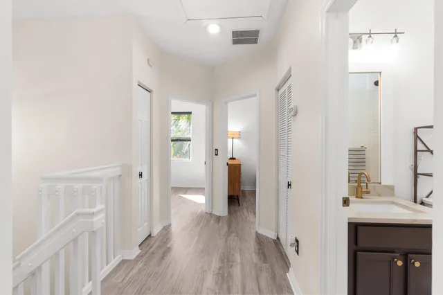 a view of a hallway with wooden floor