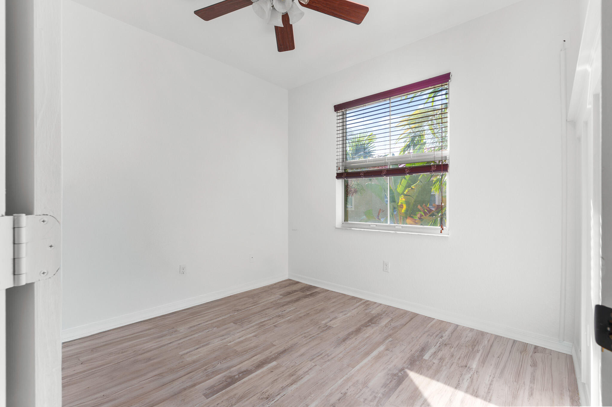 155 Monterey Bay Drive Boynton Beach, FL 33426 - Photo 25 of 37 an empty room with a window and wooden floor