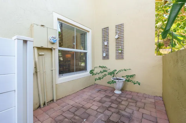 a bath room with a door and a potted plant