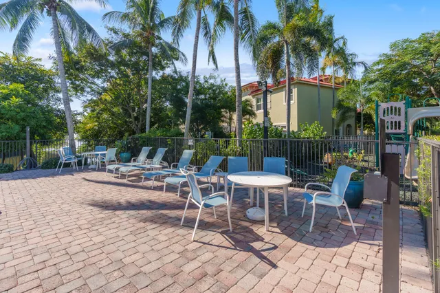 a view of a patio with a dining table and chairs with a patio
