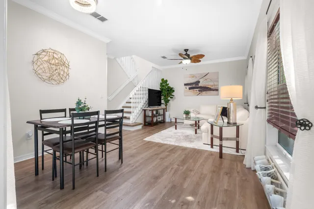 a view of a dining room with furniture wooden floor and a chandelier