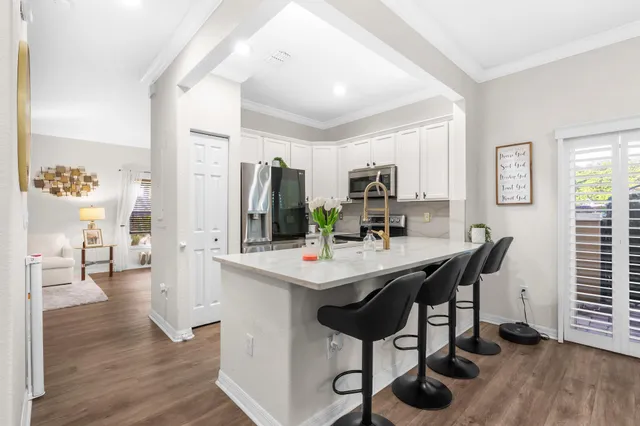 a view of a dining room with furniture and wooden floor