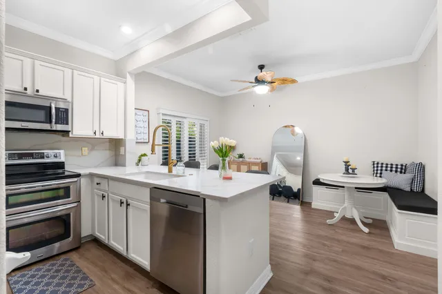 a kitchen with a sink stove and cabinets