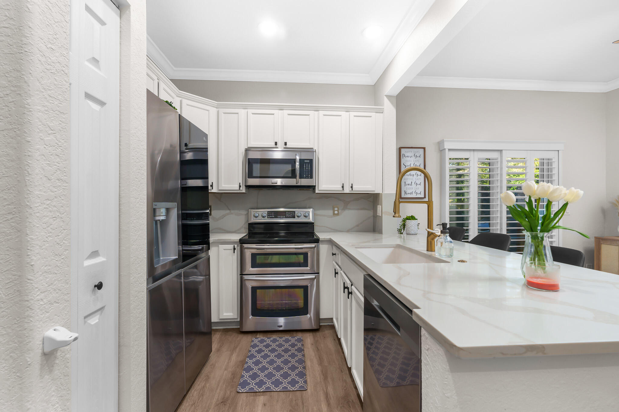 155 Monterey Bay Drive Boynton Beach, FL 33426 - Photo 10 of 37 a kitchen with stainless steel appliances a sink a stove a refrigerator cabinets and a counter space