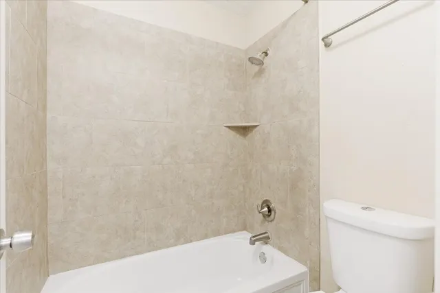 a bathroom with a bathtub and a toilet